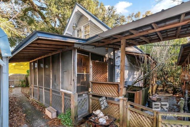 view of outdoor structure featuring a sunroom