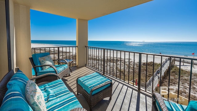 balcony featuring a water view and a view of the beach