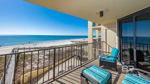 balcony featuring a water view and a beach view