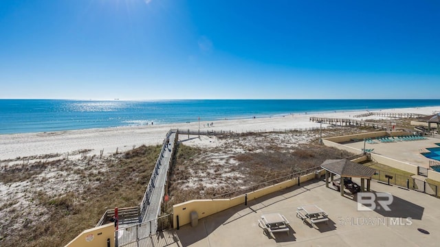 water view with fence and a beach view