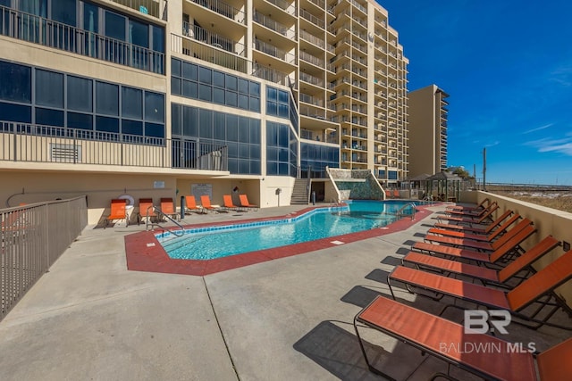 community pool featuring a patio area