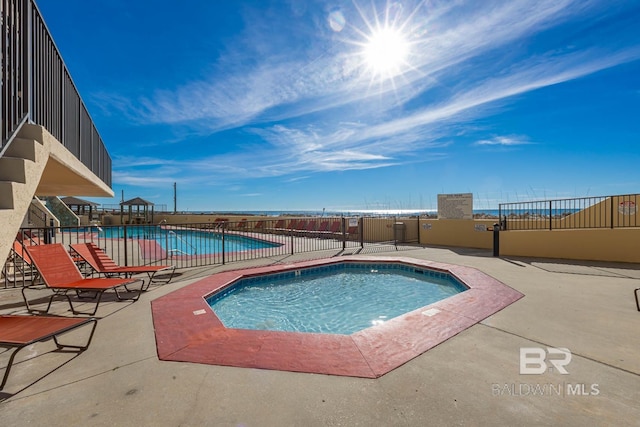 community pool with a patio area