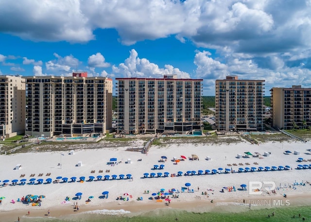 birds eye view of property with a view of the beach, a water view, and a view of city