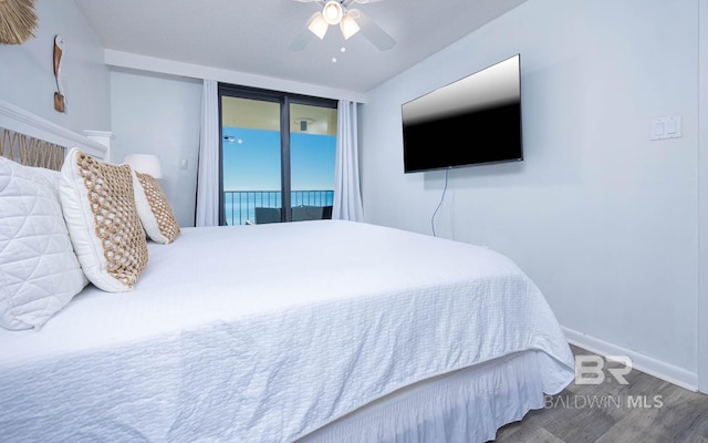 bedroom with access to exterior, a ceiling fan, baseboards, and wood finished floors