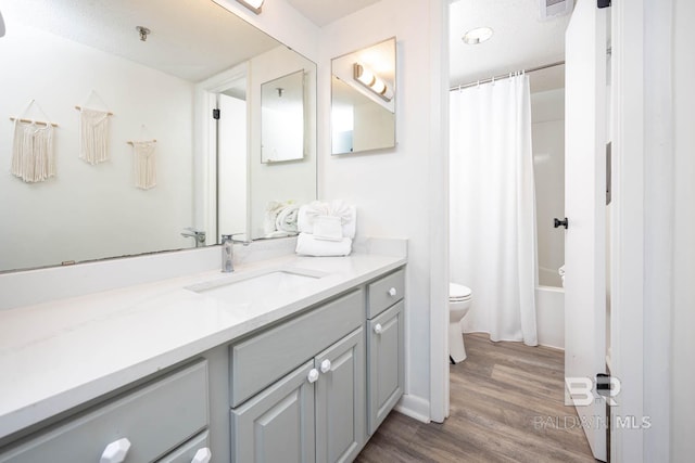 full bath featuring visible vents, wood finished floors, vanity, and toilet