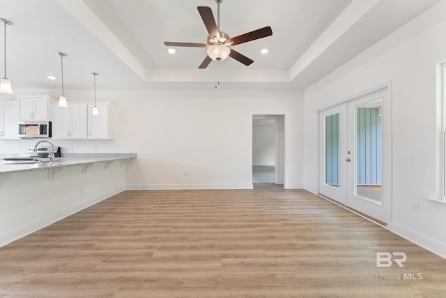 1819 Mary Jane Dr, Bay Minette, AL 36507 - unfurnished living room with recessed lighting, a tray ceiling, a ceiling fan, and light wood-style floors