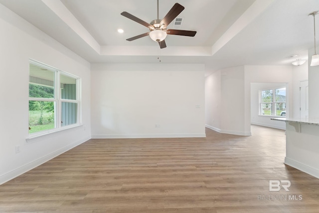 1819 Mary Jane Dr, Bay Minette, AL 36507 - spare room featuring visible vents, baseboards, a raised ceiling, a ceiling fan, and light wood-style flooring