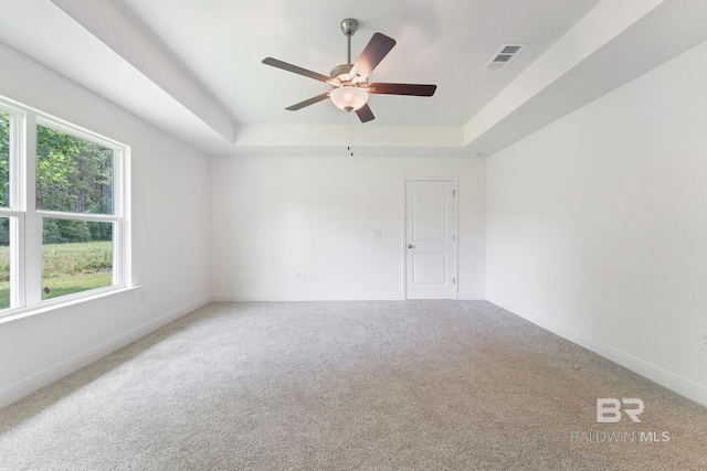 1819 Mary Jane Dr, Bay Minette, AL 36507 - carpeted spare room featuring visible vents, baseboards, ceiling fan, and a tray ceiling