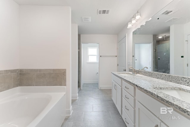 1819 Mary Jane Dr, Bay Minette, AL 36507 - bathroom with visible vents, a sink, a garden tub, and a stall shower