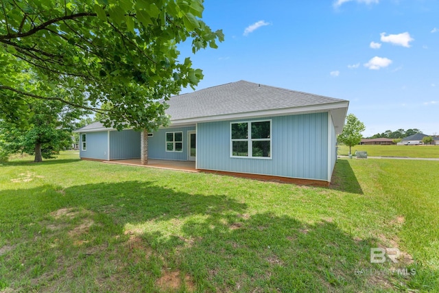 1819 Mary Jane Dr, Bay Minette, AL 36507 - back of property featuring a lawn, a patio area, and roof with shingles