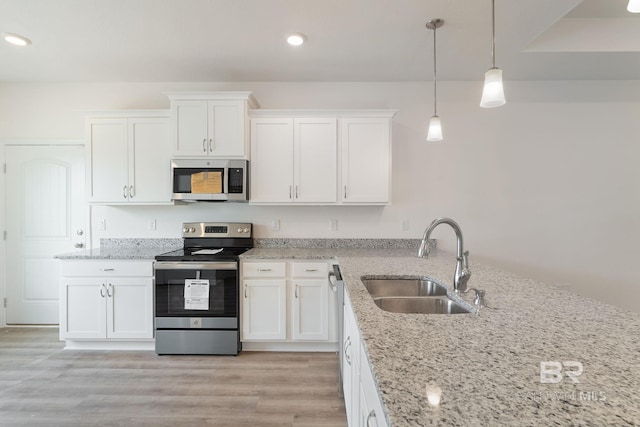 1819 Mary Jane Dr, Bay Minette, AL 36507 - kitchen featuring light stone counters, a sink, white cabinets, and stainless steel appliances