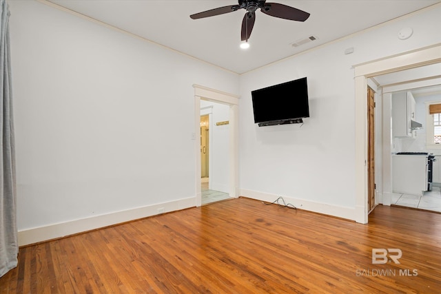 unfurnished room featuring crown molding, hardwood / wood-style flooring, and ceiling fan