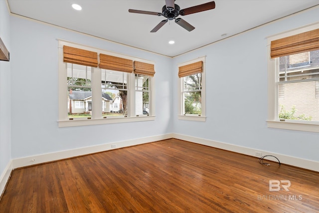 empty room featuring hardwood / wood-style floors, a wealth of natural light, and ceiling fan