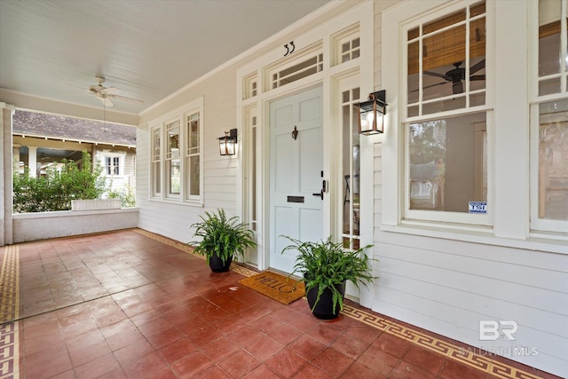 unfurnished sunroom with ceiling fan