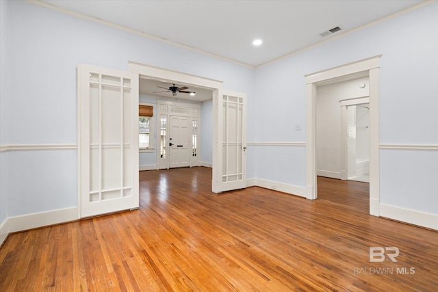 unfurnished room with hardwood / wood-style flooring, ornamental molding, and ceiling fan