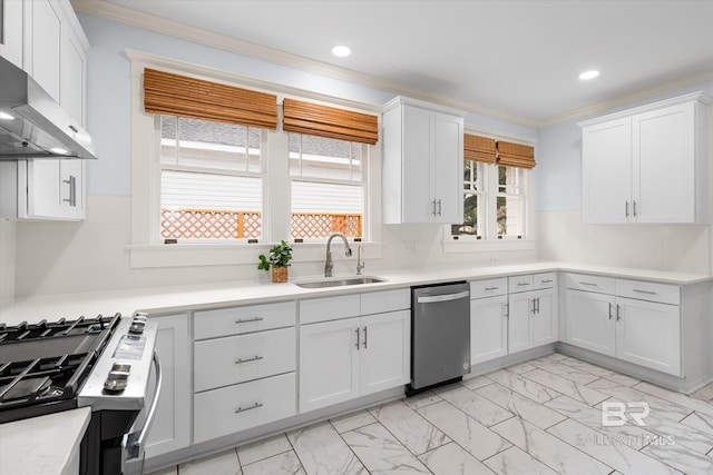 kitchen featuring wall chimney range hood, white cabinets, sink, and dishwasher