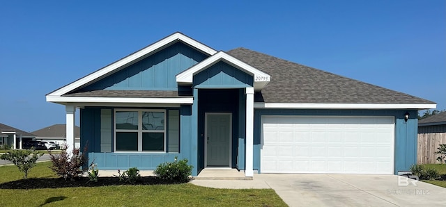 ranch-style home with a garage, board and batten siding, roof with shingles, and driveway