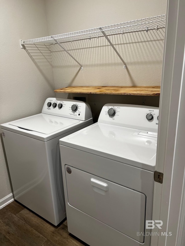 laundry area with dark wood-type flooring, separate washer and dryer, and laundry area