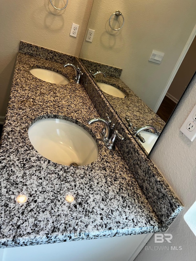 bathroom featuring double vanity and a sink