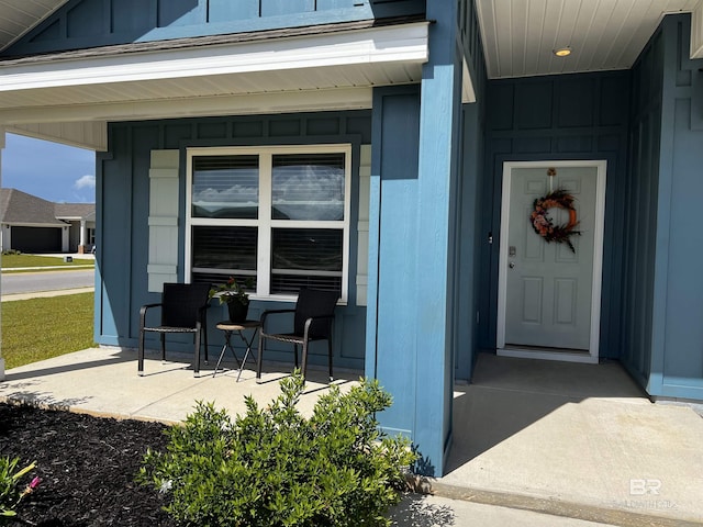 entrance to property featuring board and batten siding and a porch