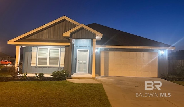 view of front facade with board and batten siding, a garage, and driveway