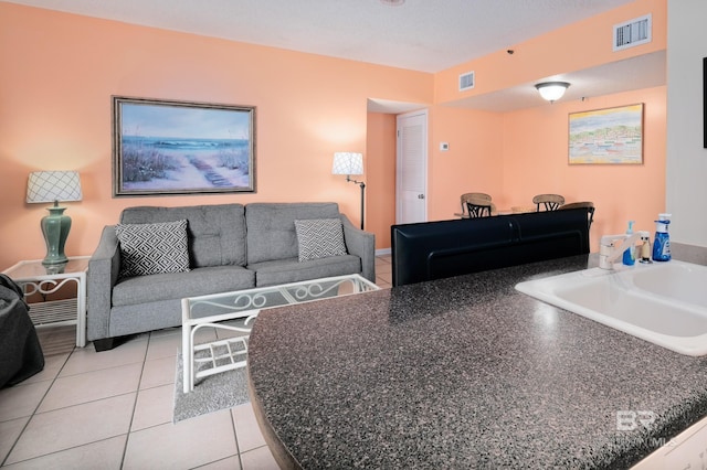 living room with sink and light tile patterned flooring