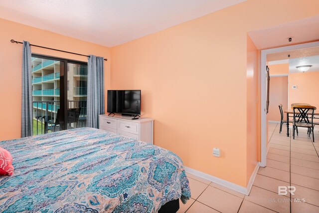 bedroom with light tile patterned flooring and access to outside