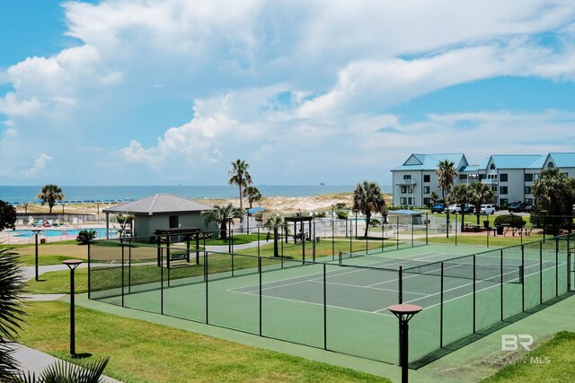 view of tennis court with a community pool