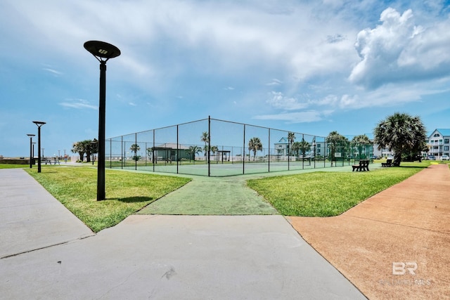 surrounding community with a yard and tennis court