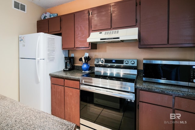 kitchen with stainless steel appliances and a textured ceiling