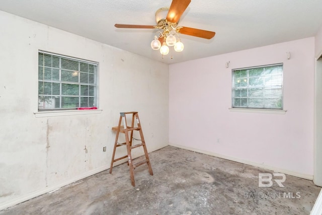 3909 Blue Gill Cir, Mobile, AL 36619 - empty room featuring unfinished concrete floors and ceiling fan