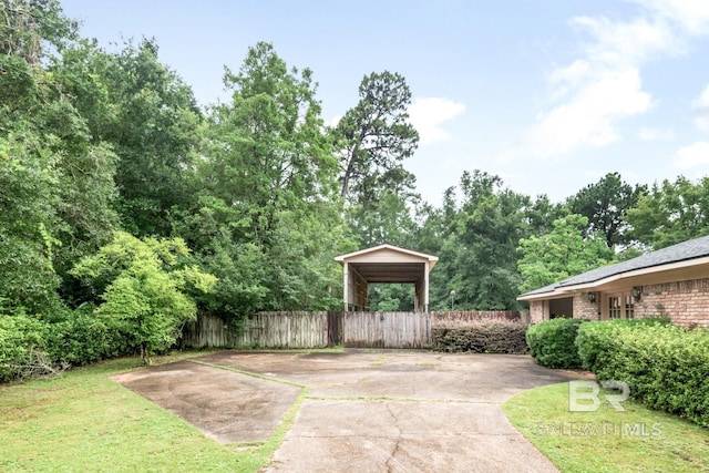 3909 Blue Gill Cir, Mobile, AL 36619 - view of patio featuring a carport and driveway