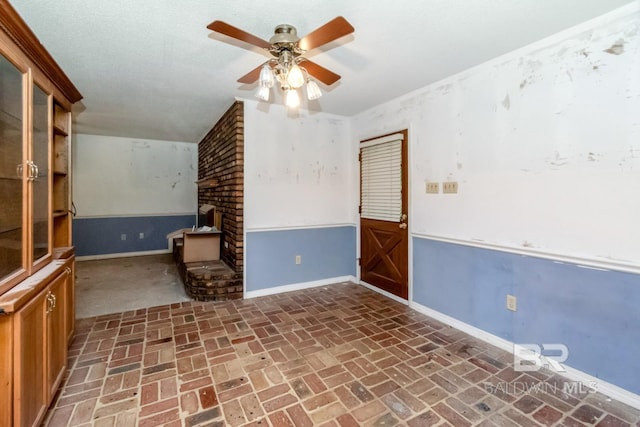 3909 Blue Gill Cir, Mobile, AL 36619 - unfurnished living room featuring brick floors, ceiling fan, and a brick fireplace