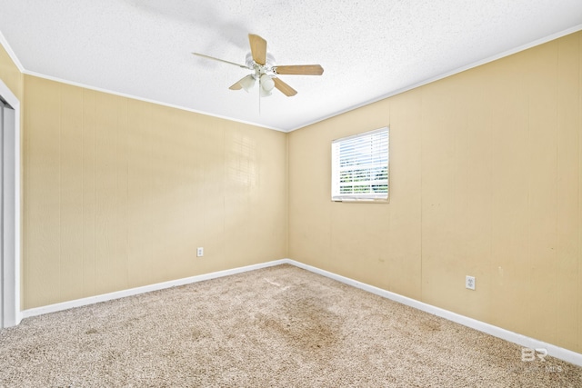 carpeted spare room with ceiling fan, a textured ceiling, and crown molding