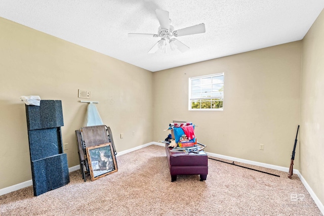 playroom with ceiling fan, a textured ceiling, and carpet flooring