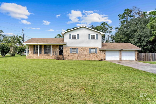 split level home featuring a garage and a front lawn