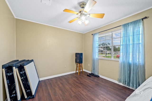 interior space with ceiling fan, a textured ceiling, dark hardwood / wood-style floors, and ornamental molding