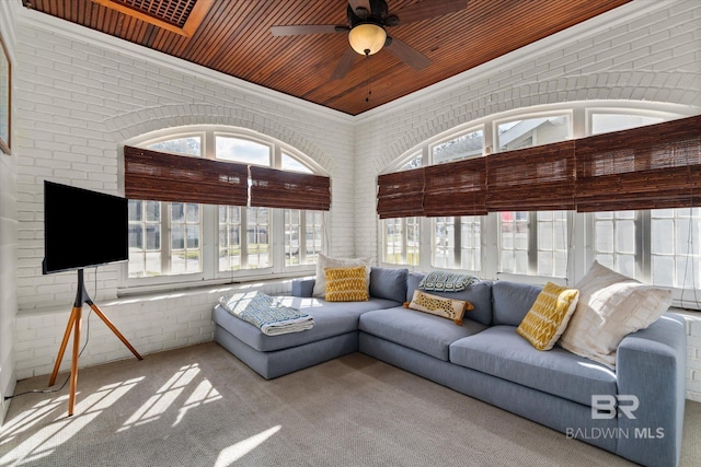 sunroom / solarium with wooden ceiling and a ceiling fan