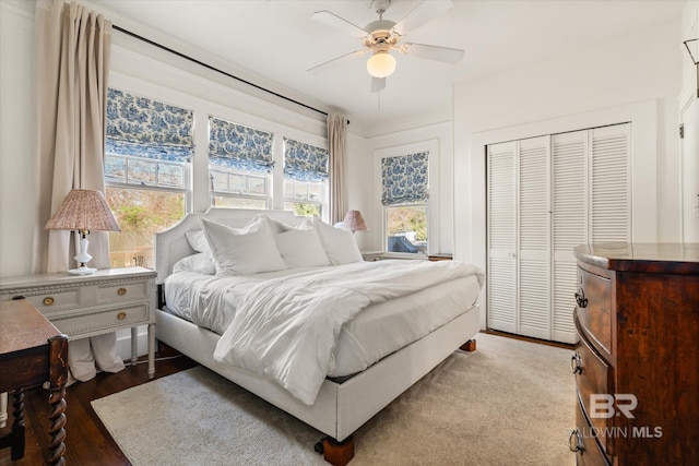 bedroom featuring a closet, a ceiling fan, and wood finished floors