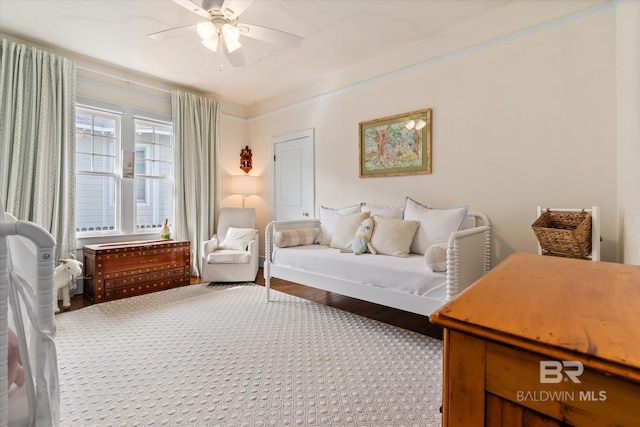 bedroom with a ceiling fan and wood finished floors