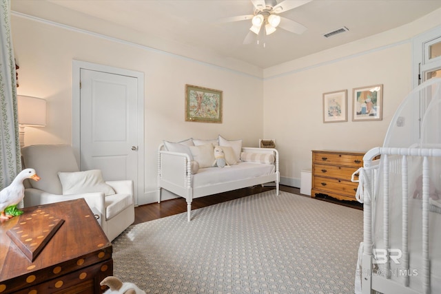 bedroom featuring a ceiling fan, wood finished floors, and visible vents