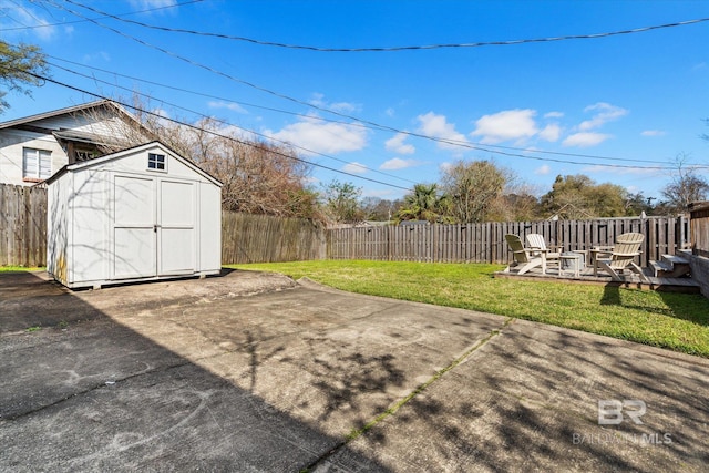 view of yard featuring a patio area, a fenced backyard, a storage shed, and an outdoor structure