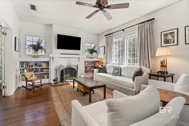 living area featuring plenty of natural light, visible vents, and dark wood-style flooring