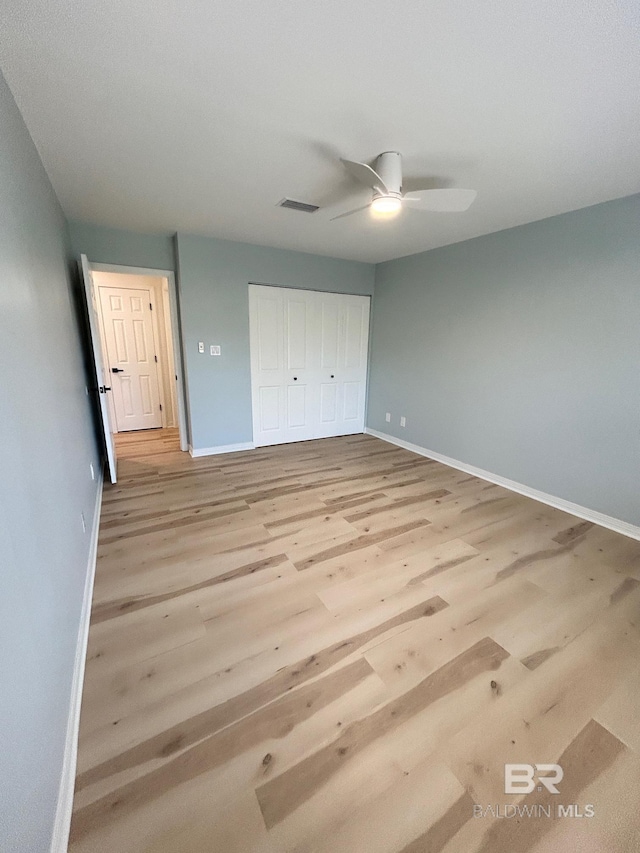 unfurnished bedroom with baseboards, light wood-style floors, and visible vents