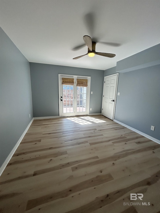 unfurnished bedroom featuring light wood-style flooring, baseboards, a ceiling fan, and access to exterior