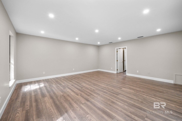 spare room with visible vents, baseboards, wood finished floors, and recessed lighting