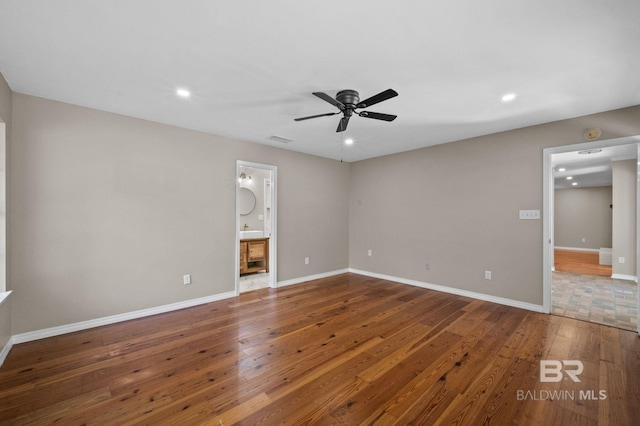 spare room with ceiling fan, hardwood / wood-style flooring, recessed lighting, visible vents, and baseboards