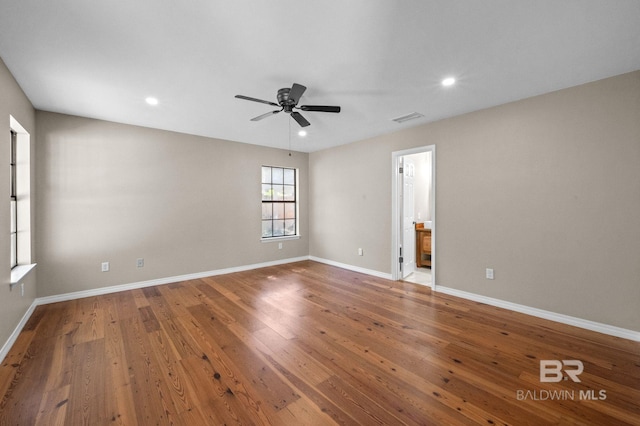 spare room featuring baseboards, visible vents, a ceiling fan, hardwood / wood-style floors, and recessed lighting