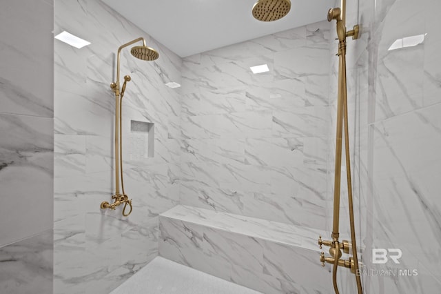 full bathroom with a marble finish shower