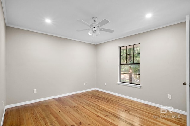 empty room with ornamental molding, a ceiling fan, light wood-style flooring, and baseboards